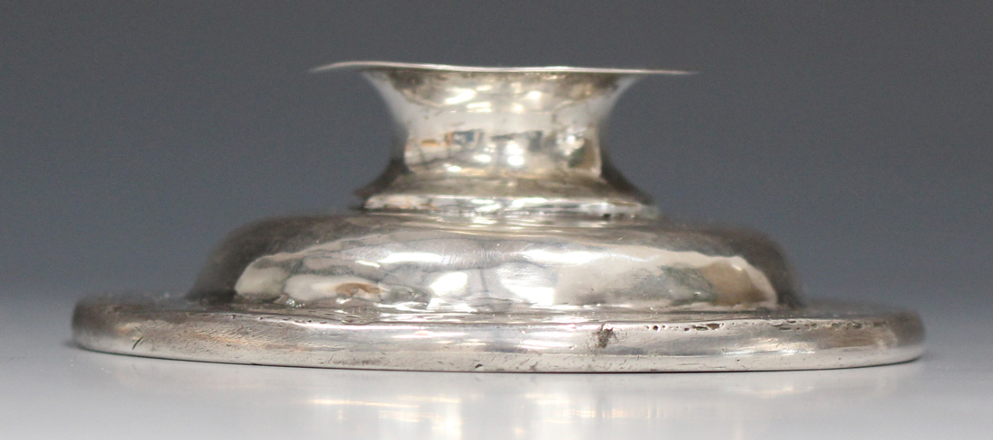 An Elizabeth I silver chalice cover of domed form with flattened finial and engraved rim, London