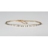 An 18ct gold, white gold, diamond and cultured pearl bracelet, the front mounted with a row of eight