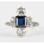 A diamond and sapphire ring, mounted with the square step cut sapphire to the centre, between two