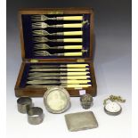 A small group of silver, including a cigarette case, Chester 1932, a pair of napkin rings, Sheffield