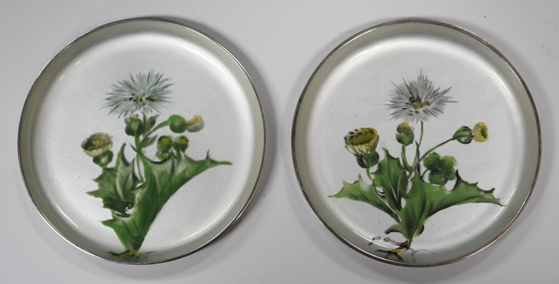 A pair of Danish sterling and enamelled circular pin dishes, each interior decorated with a stem