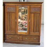 An Edwardian walnut wardrobe, the moulded pediment above two doors with carved and moulded