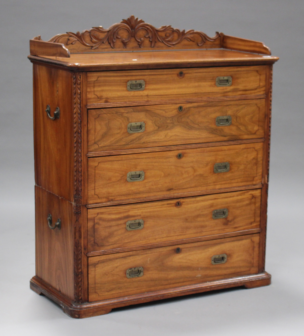 A 20th century camphor campaign style chest, fitted with a carved gallery above five long drawers