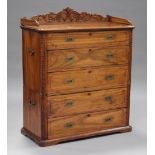 A 20th century camphor campaign style chest, fitted with a carved gallery above five long drawers