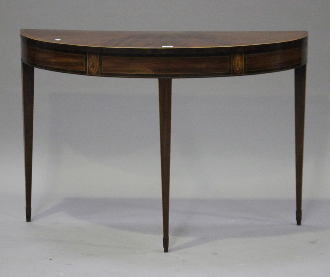 A George III mahogany demi-lune side table with crossbanded and line inlaid decoration, raised on