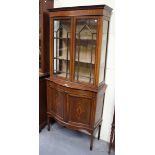 An Edwardian mahogany and inlaid display cabinet, the moulded top above astragal glazed doors and