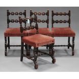 A set of four early 20th century carved oak bar back chairs, the overstuffed seats on shaped legs,