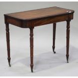 A George IV mahogany side table with crossbanded and ebonized decoration, raised on turned legs