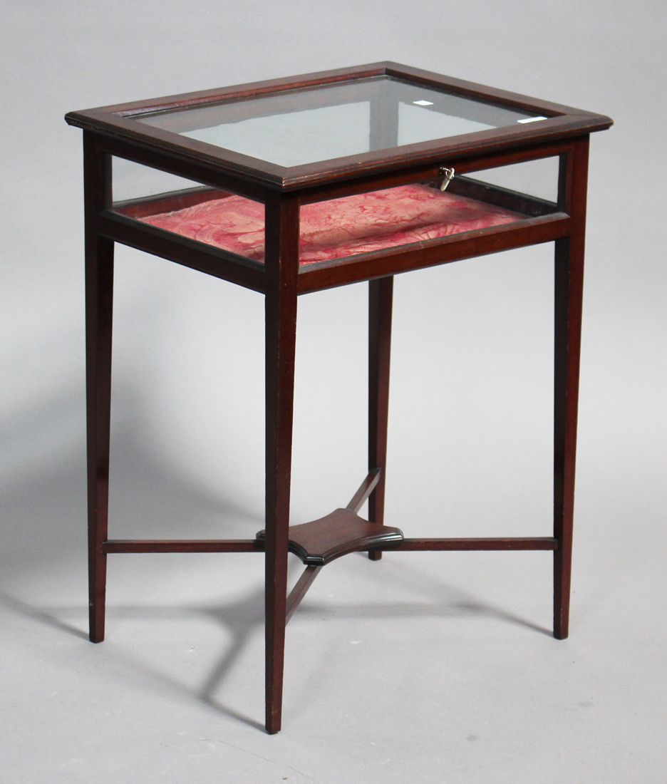 An Edwardian mahogany bijouterie table, the glazed top and sides raised on square tapering legs