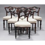 A set of six William IV rosewood dining chairs with carved foliate backs, the overstuffed seats