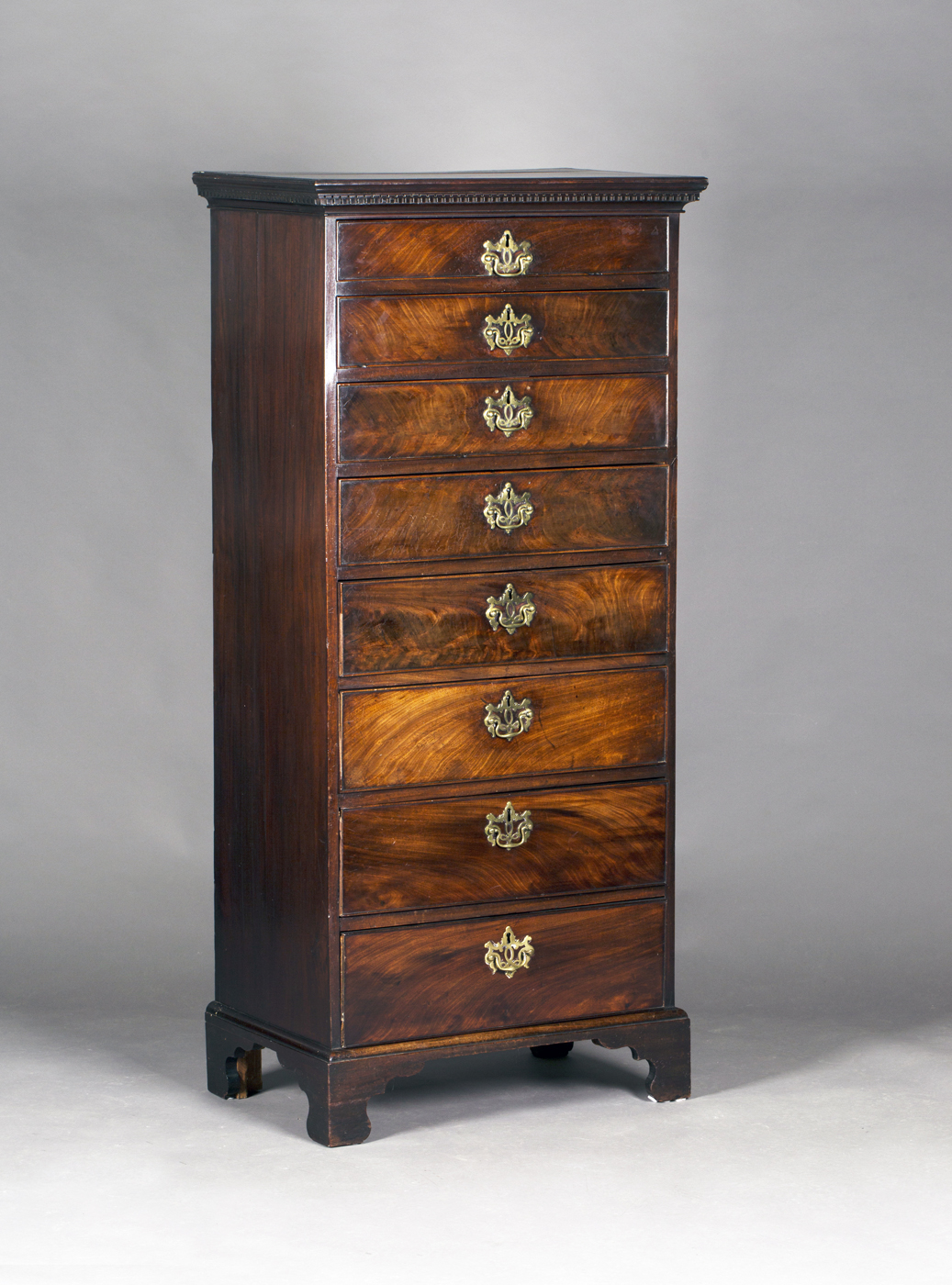 An unusual George III mahogany narrow chest of eight graduated drawers, raised on bracket feet,