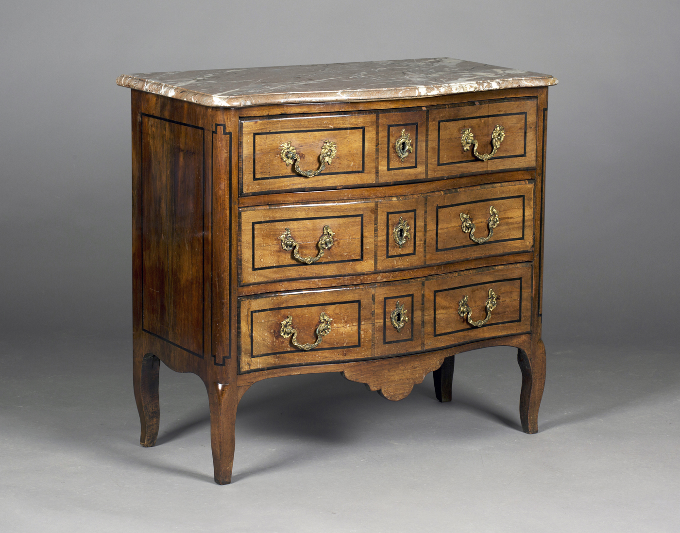 A 19th century French walnut and rosewood crossbanded commode, the shaped rouge marble top above