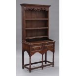 A 20th century George III style oak dresser, the shelf back with a moulded and pierced pediment, the