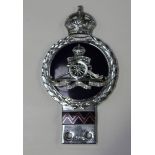 A chrome plated metal and enamelled pre-1953 motor car badge bearing the crown, crest and colours of