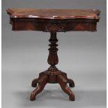 A Victorian walnut serpentine fronted card table, raised on a turned and carved column, with