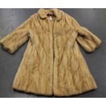 An early/mid-20th century pale mink three-quarter-length lady's coat, bearing label marked '