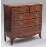 A 19th century mahogany bowfront chest of two short and three long drawers, with chequer