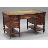 A late Victorian walnut breakfront twin pedestal desk by Maple & Co, the moulded top inset with