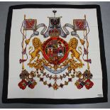 An Hermès printed silk scarf, decorated with a coat-of-arms and marked 'Hermès Paris', 87cm x 85cm.