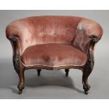 A Victorian walnut low-backed salon armchair, upholstered in pink velour, on carved cabriole legs,