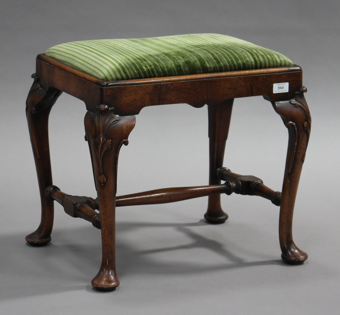 A 20th century Queen Anne style walnut stool with drop-in seat, raised on carved cabriole legs and
