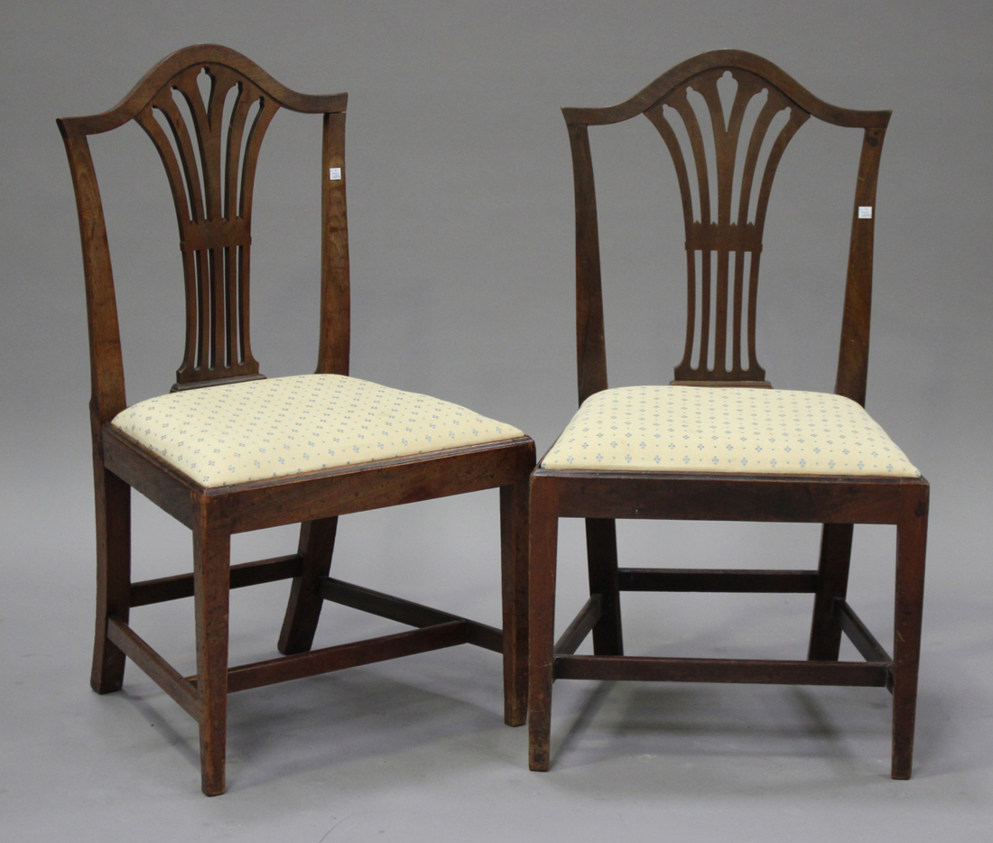 A set of six late George III mahogany pierced splat back dining chairs with drop-in seats, on square