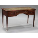 An Edwardian mahogany writing table, fitted with three drawers, on square tapering legs and castors,