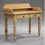 A Victorian stripped pine washstand, the three-quarter gallery back above two frieze drawers, raised