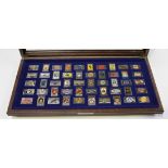 A collection of fifty silver and enamelled ingots, each decorated with a different car badge, import