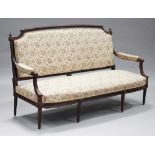 A late 19th/early 20th century French Louis XVI style rosewood framed salon settee with carved