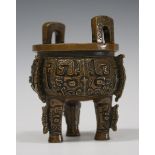 A Chinese archaistic brown patinated bronze tripod censer, late Qing dynasty, the compressed