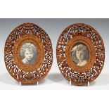 A pair of Chinese sandalwood oval frames, 20th century, each carved and pierced in high relief