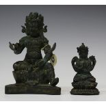 A Tibetan bronze figure of a Buddhistic guardian deity, 19th century, modelled seated wearing