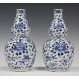 A pair of Chinese blue and white porcelain double gourd vases, mark of Kangxi but late 19th century,