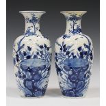 A pair of Chinese blue and white porcelain vases, mark of Kangxi but late 19th century, each