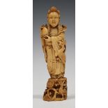 A Chinese carved and stained ivory figure of a female immortal, late Qing dynasty, modelled standing