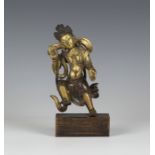 A Sino-Tibetan gilt and brown patinated bronze figure of a bodhisattva, Qing dynasty, modelled