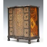 A Japanese parquetry inlaid and lacquer table-top cabinet, Meiji period, the serpentine front and