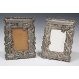 A pair of Japanese antimony photograph frames, early 20th century, each cast in relief with