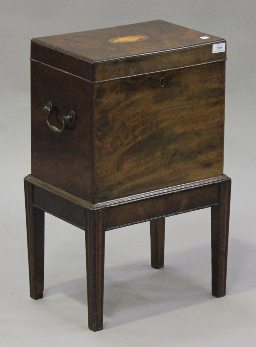 A George III mahogany rectangular cellaret and stand, the hinged lid inlaid with and oval shell