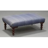 A 20th century reproduction mahogany footstool, upholstered in purple fabric, on turned legs, height