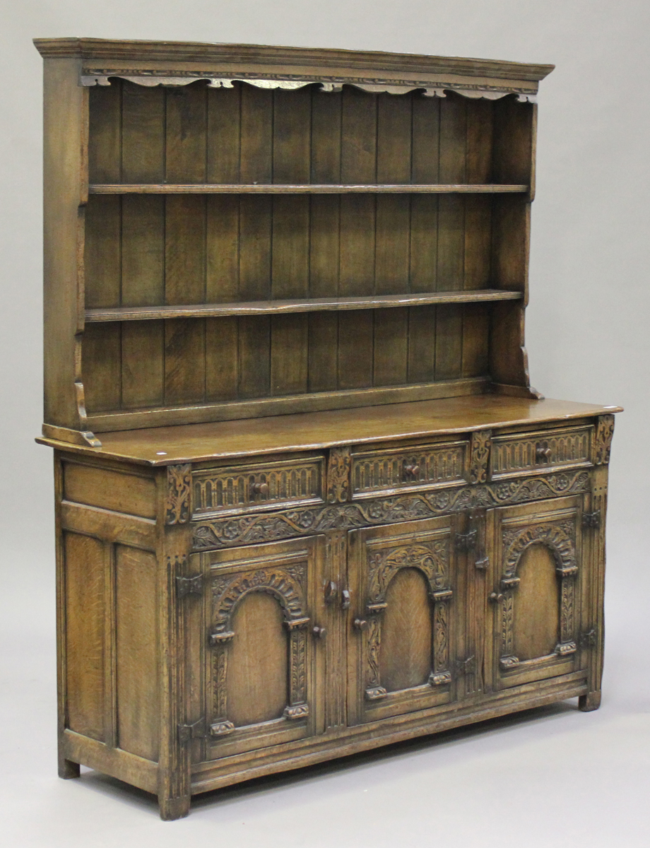 A mid-20th century Jacobean Revival oak dresser, the shelf back above three drawers and a