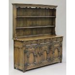 A mid-20th century Jacobean Revival oak dresser, the shelf back above three drawers and a