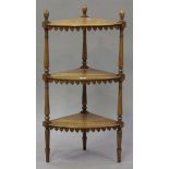 A Victorian satin birch three-tier corner whatnot with turned finials and fretwork aprons, height