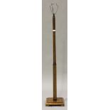 An Art Deco walnut lamp standard on a square stepped base, height 154cm.Buyer’s Premium 29.4% (