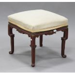 An early 20th century chinoiserie stool, the overstuffed seat raised on red and gilt painted legs,