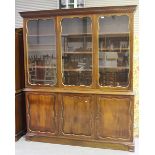 An early 20th century mahogany library bookcase cabinet, in the manner of Waring & Gillows, the