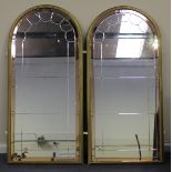 A pair of Art Deco arched sectional hall mirrors with peach tinted borders and gilt frames, 165cm