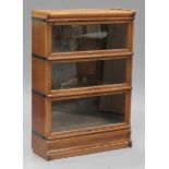 An early 20th century oak Globe Wernicke three-section glazed bookcase, with transferred maker's