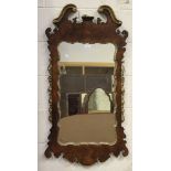 A 20th century George II style walnut framed wall mirror with gilded mouldings and floral swags